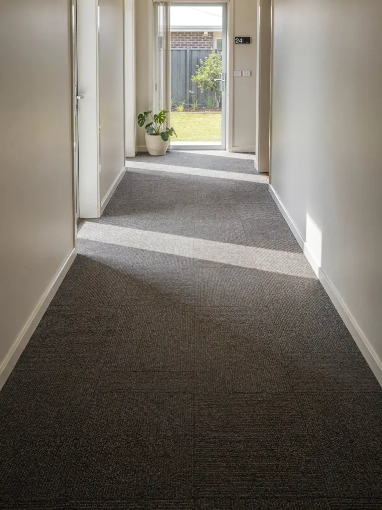 Freshly cleaned corporate office corridor with groomed low-pile carpet in Rockingham.